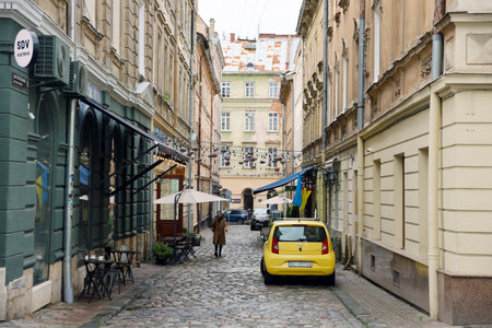LVIV, UKRAINE - SEPTEMBER 11, 2022 Street view of the historical old city in Lviv, Ukraine. Many old buildings and facade ornaments in tight european style streets of Lvivのeditorial素材