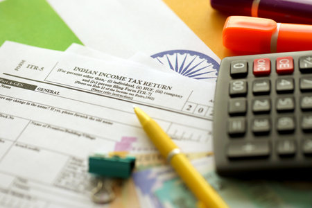 KYIV, UKRAINE - MAY 4, 2022 Indian income tax return blank form with pen and indian rupees bills on indian country flag close up. Annual tax report conceptのeditorial素材