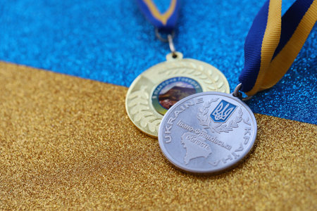 KYIV, UKRAINE - MAY 4, 2022 Medal for the person who conquered Mount Hoverla. Ukrainian tourist souvenir award on a ribbon with the colors of the Ukrainian flagのeditorial素材