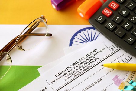 KYIV, UKRAINE - MAY 4, 2022 Indian income tax return blank form with pen and indian rupees bills on indian country flag close up. Annual tax report conceptのeditorial素材