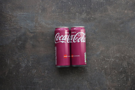 KYIV, UKRAINE - MAY 4, 2023: Coca cola soft drinks brand tin cans with cherry flavor close upのeditorial素材