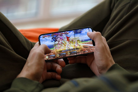 Fate Grand Order mobile iOS game on iPhone 15 smartphone screen in male hands during mobile...