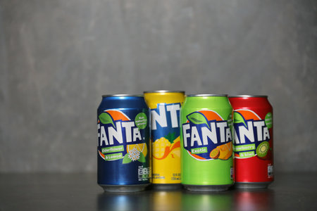 KYIV, UKRAINE - MAY 4, 2023: Fanta soft drink brand tin cans with various flavors close up