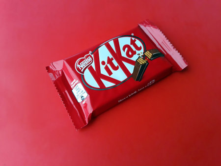 KHARKIV, UKRAINE - JANUARY 2, 2021 Kit Kat by Nestle chocolate covered wafer on bright color...