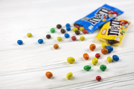 KHARKIV, UKRAINE - JANUARY 2, 2021 M and Ms colorful button shaped chocolate candies. Multi colored chocolates each of which has the letter m printed in lower case in white on one sideのeditorial素材