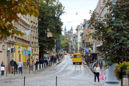 LVIV, UKRAINE - SEPTEMBER 11, 2022 Street view of the historical old city in Lviv, Ukraine. Many old buildings and facade ornaments in tight european style streets of Lvivのeditorial素材