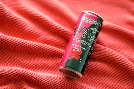 KYIV, UKRAINE - JULY 7, 2023 Coca-Cola zero sugar can with Rosalia design limited edition on red fabric backgroundのeditorial素材