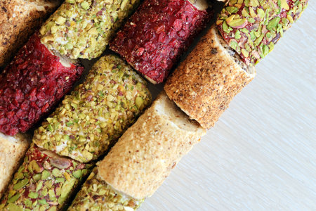 Rolls of turkish delight with many different flavors and fillings close up on table of vendors...