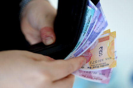 Woman hand with indian rupees bills close up. Concept of financial operations in cash in India