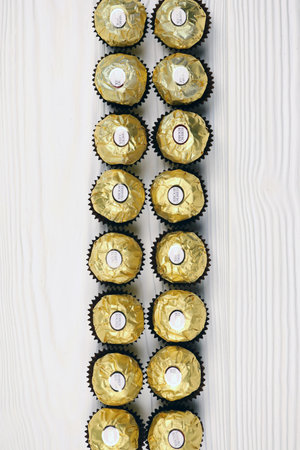 KHARKIV, UKRAINE - JANUARY 2, 2021 Ferrero Rocher - round chocolates. Candy in branded packaging, a sweet pleasure for children and adultsのeditorial素材