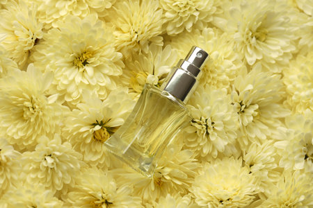 Women fragrance perfume bottle with flowers background close up. Unnamed blank sprayer bottle of...