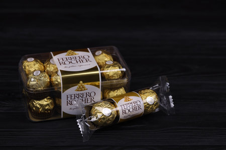 KHARKIV, UKRAINE - JANUARY 2, 2021 Ferrero Rocher - round chocolates. Candy in branded packaging, a sweet pleasure for children and adultsのeditorial素材