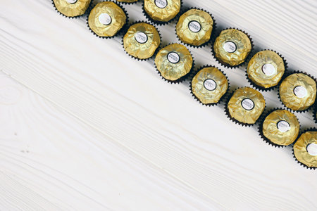 KHARKIV, UKRAINE - JANUARY 2, 2021 Ferrero Rocher - round chocolates. Candy in branded packaging, a sweet pleasure for children and adultsのeditorial素材