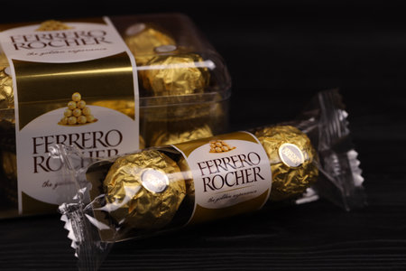 KHARKIV, UKRAINE - JANUARY 2, 2021 Ferrero Rocher - round chocolates. Candy in branded packaging, a sweet pleasure for children and adultsのeditorial素材