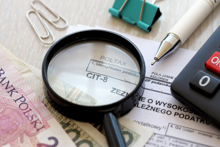 Declaration of the amount of earned income or incurred loss and corporate income tax, CIT-8 tax forms on accountant table with pen and polish zloty money bills close upの写真素材