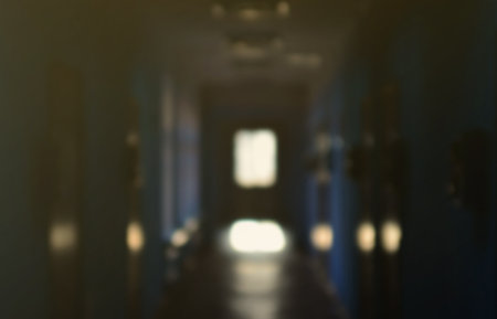 The blurred image of gloomy corridor of a neglected public building. Defocused picture of a public space in a poor residential high-rise buildingの写真素材