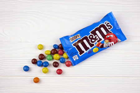 KHARKIV, UKRAINE - JANUARY 2, 2021 M and Ms colorful button shaped chocolate candies. Multi colored chocolates each of which has the letter m printed in lower case in white on one sideのeditorial素材