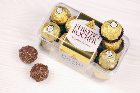 KHARKIV, UKRAINE - JANUARY 2, 2021 Ferrero Rocher - round chocolates. Candy in branded packaging, a sweet pleasure for children and adultsのeditorial素材