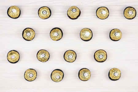 KHARKIV, UKRAINE - JANUARY 2, 2021 Ferrero Rocher - round chocolates. Candy in branded packaging, a sweet pleasure for children and adultsのeditorial素材