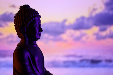 Buddha Purnima and Vesak day concept, Buddha statue with low key light against beautiful and...