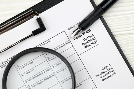 IRS Form W-2G Certain Gambling Winning blank on A4 tablet lies on office table with pen and...