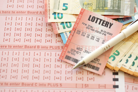 Lottery ticket and gambling receipt on table with pen and European Union euro money bills close upの写真素材