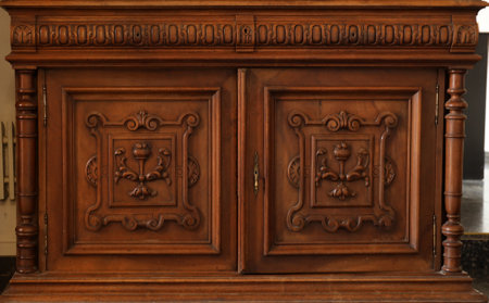 Old vintage wardrobe furniture with ornamental doors and retro colors of wooden surfaces close upの写真素材