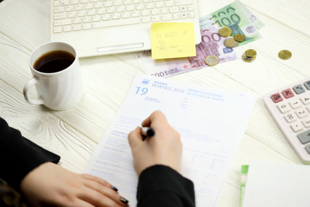 Accountant fill french tax form 2042 NR departure abroad or return to France in end of tax period. Taxation and paperwork routine in Franceの写真素材