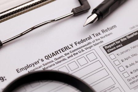 IRS Form 941-SS Employers quarterly federal tax return blank on A4 tablet lies on office table with...