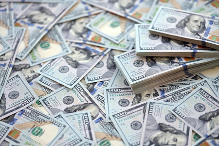 Very big amount of US hundred dollar bills close up. Huge quantity of united states currency notes on flat tableの写真素材