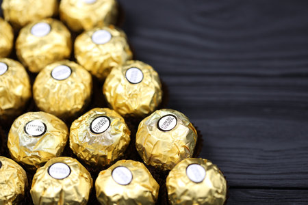 KHARKIV, UKRAINE - JANUARY 2, 2021 Ferrero Rocher - round chocolates. Candy in branded packaging, a sweet pleasure for children and adultsのeditorial素材