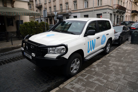 KYIV, UKRAINE - 4 MAY, 2023: Logo of UN United Nations OCHA on doors of white SUV car close up