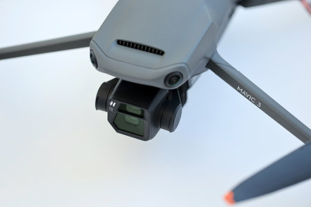 KYIV, UKRAINE - 4 MAY, 2023: new DJI Mavic 3 fly more combo quadrocopter drone on light background