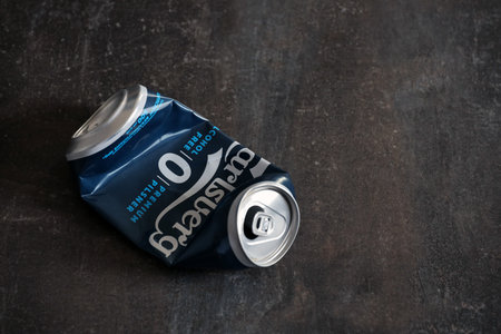 KYIV, UKRAINE - 4 MAY, 2023: Carlsberg zero alcohol or non alcohol crumpled aluminium tin can close...