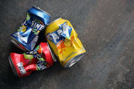 KYIV, UKRAINE - 4 MAY, 2023: Fanta soft drink brand crumpled tin cans with various flavours close upのeditorial素材