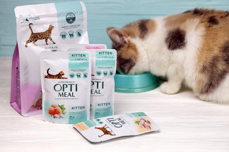 KHARKIV, UKRAINE - JANUARY 2, 2021 Optimeal cat meal packs. Optimeal is product by Kormotech LLC, a global family company with Ukrainian roots, the largest producer of pet food in Ukraineのeditorial素材
