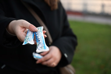 KYIV, UKRAINE - OCTOBER 31, 2023 Bounty chocolate bars with cocoa flavor filling in female hand....