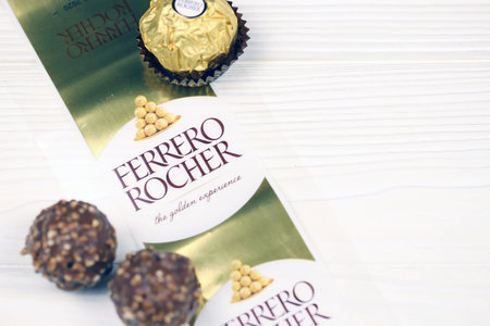 KHARKIV, UKRAINE - JANUARY 2, 2021 Ferrero Rocher - round chocolates. Candy in branded packaging, a sweet pleasure for children and adultsのeditorial素材