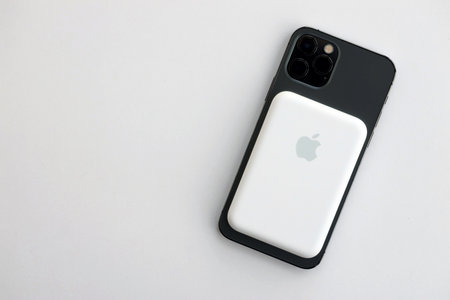 KYIV, UKRAINE - OCTOBER 31, 2023 Apple MagSafe battery device for iPhone charging via magnet...