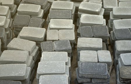 Pile of gray and dark grey walkway slab lying down outdoor. Material for Paving Slabs by mosaic...