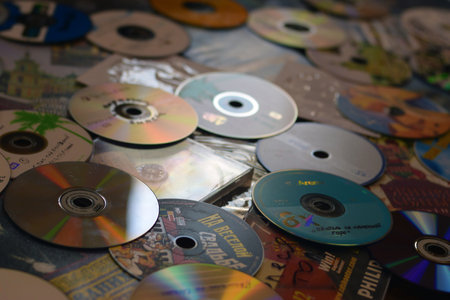 KYIV, UKRAINE - 4 MAY, 2023: Many old CDs represent technology from the 90s. Stacks of CDs, old songs and old movies. which had been used beforeのeditorial素材