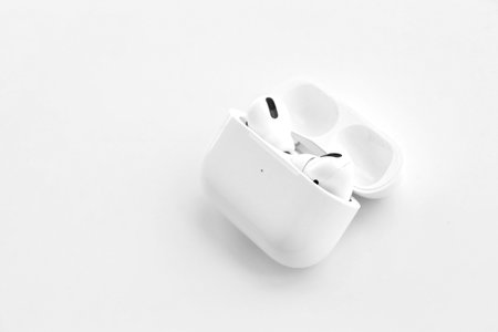KYIV, UKRAINE - 4 MAY, 2023: Apple AirPods Pro on a white background. Wireless headphones in a charging case close-upのeditorial素材