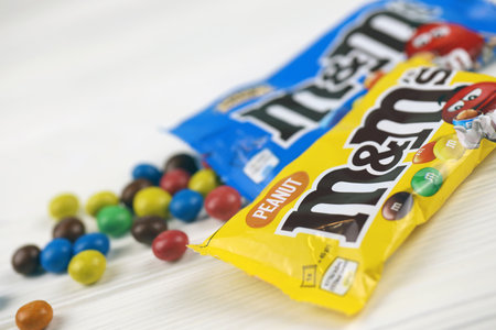 KHARKIV, UKRAINE - JANUARY 2, 2021 M and Ms colorful button shaped chocolate candies. Multi colored chocolates each of which has the letter m printed in lower case in white on one sideのeditorial素材