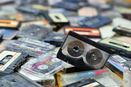 KYIV, UKRAINE - 4 MAY, 2023: Pile of audio cassettes lying on top of each other. Retro audio storage from 1980sのeditorial素材