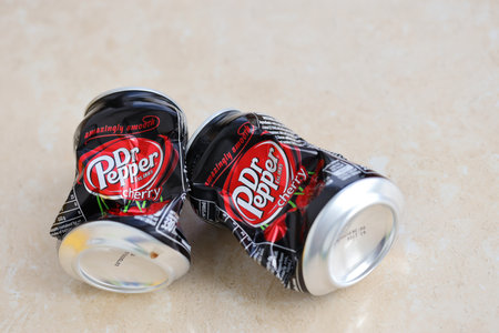 KYIV, UKRAINE - 4 MAY, 2023: Dr Pepper cherry drink black cans close up