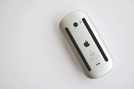 KYIV, UKRAINE - NOVEMBER 27, 2023 Apple Magic Mouse 3rd generation lies on white background close up