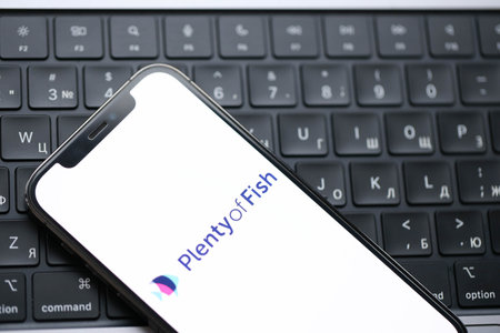 KYIV, UKRAINE - FEBRUARY 23, 2024 Plenty of Fish logo of famous dating website or app on iPhone display screen close upのeditorial素材