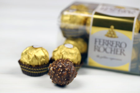 KHARKIV, UKRAINE - JANUARY 2, 2021 Ferrero Rocher - round chocolates. Candy in branded packaging, a sweet pleasure for children and adultsのeditorial素材
