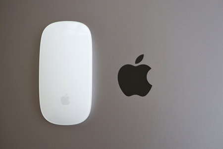 KYIV, UKRAINE - NOVEMBER 27, 2023 Apple Magic Mouse 3rd generation lies with grey MacBook 2021 close upのeditorial素材