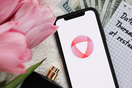 KYIV, UKRAINE - FEBRUARY 23, 2024 Open logo of famous dating website or app on iPhone display screen close upのeditorial素材